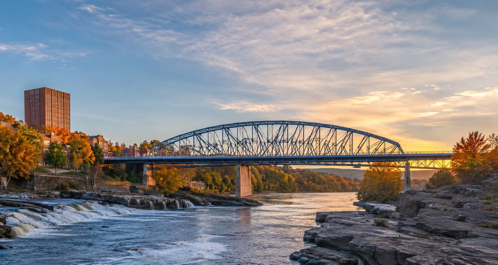 A river and bridge in a wooded landscape.